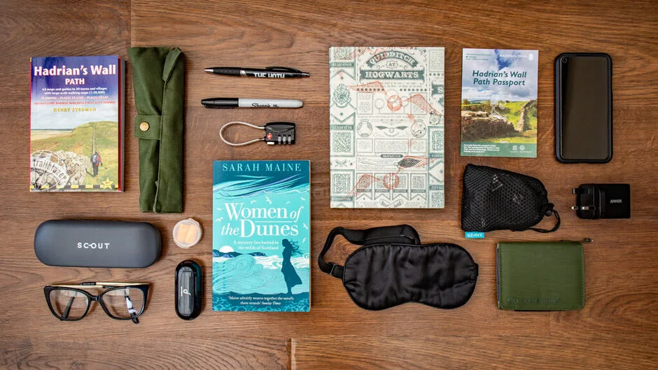 Layer in personal travel objects and books. 