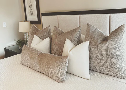 Layer 4 to 6 pillows in mixed textures. 