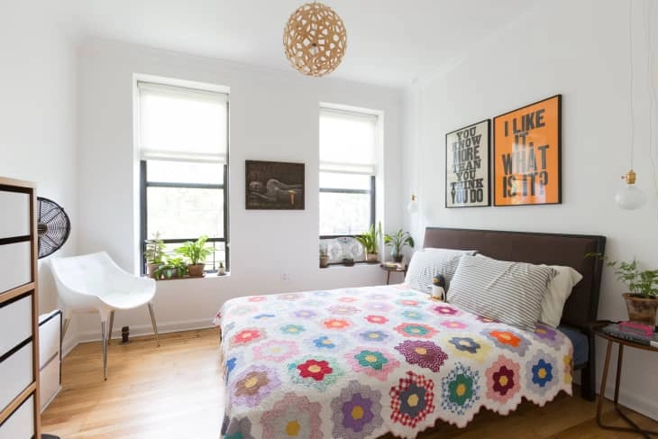 Hang one large statement piece behind the bed. 