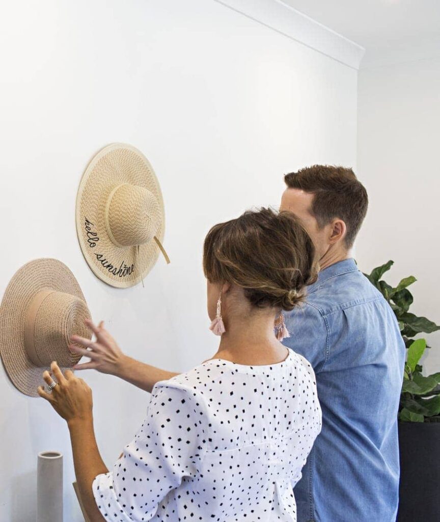 Add a wide-brim woven hat or basket cluster on one wall. 