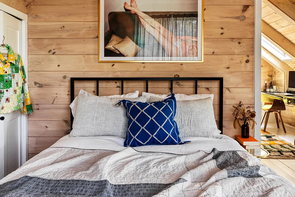Add a vintage Turkish or Moroccan tribal pillow on the bed. 