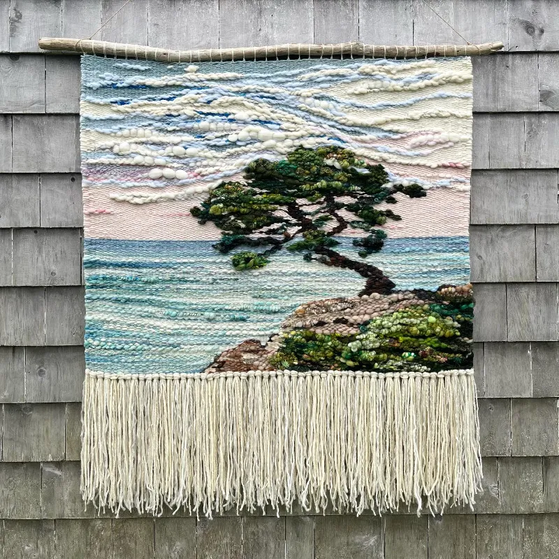 A large handmade woven fiber art piece. 