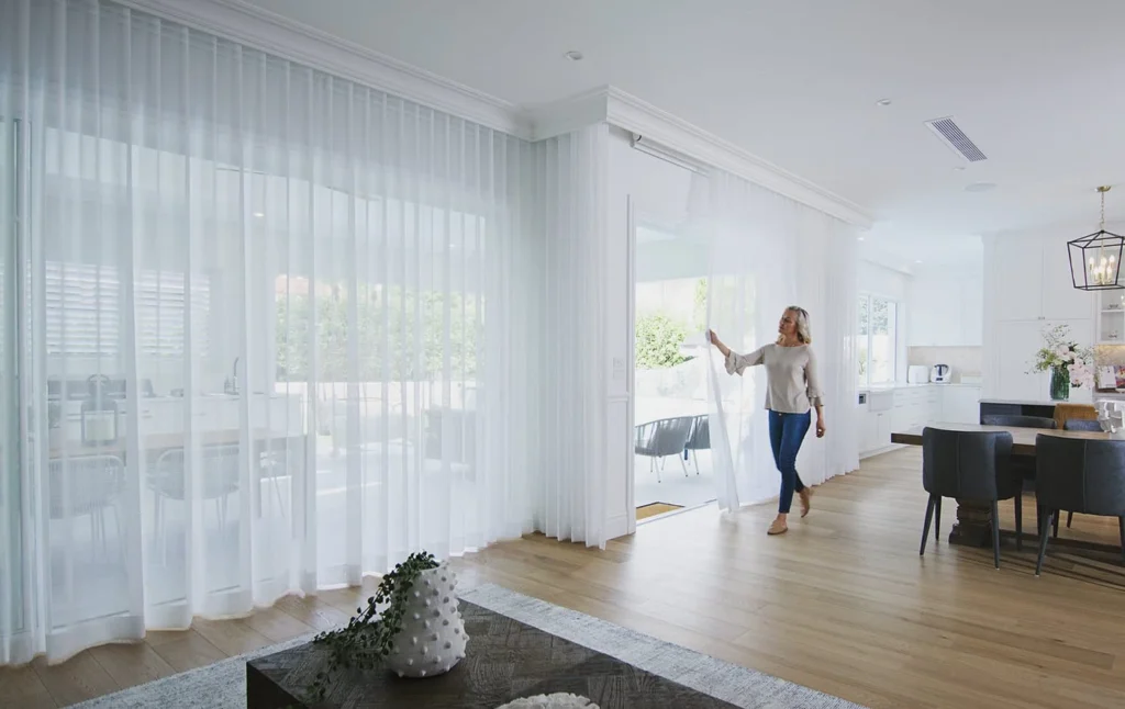 Hang heavy curtains floor-to-ceiling. 